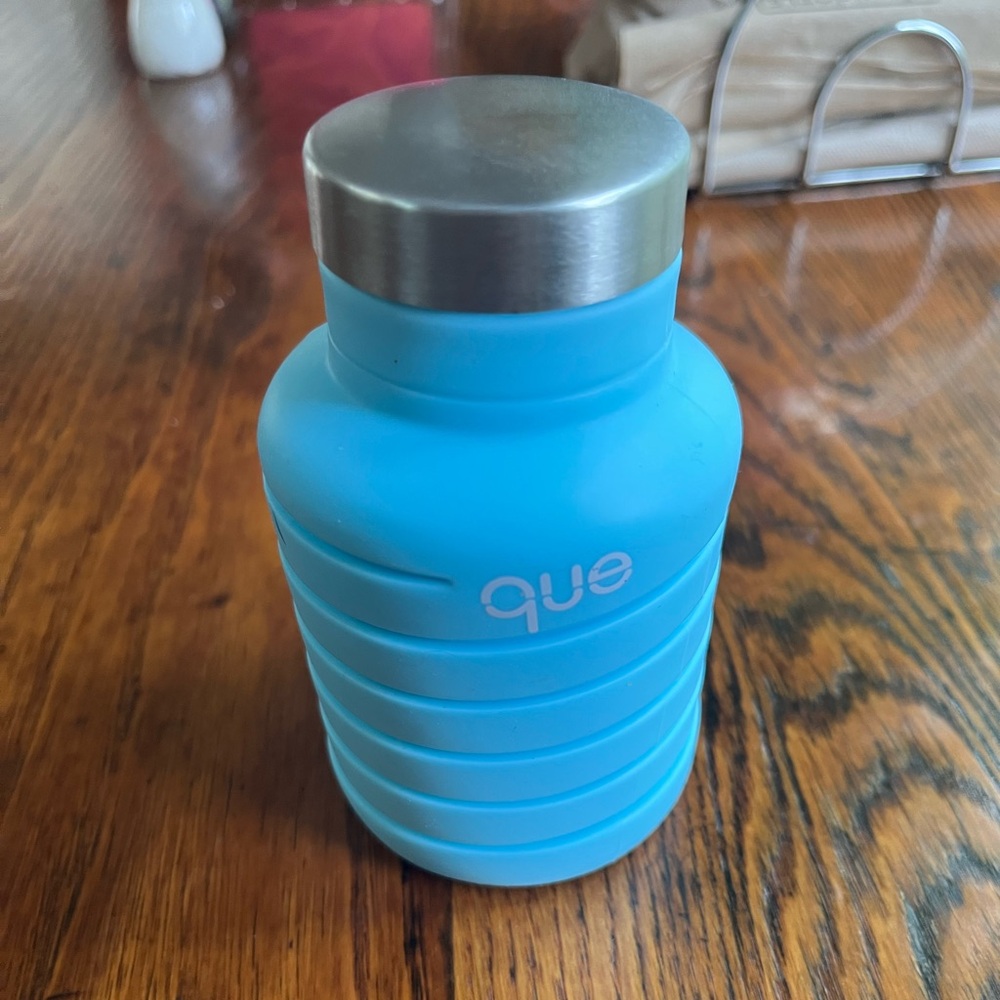 Que Bottle and makeup container.
